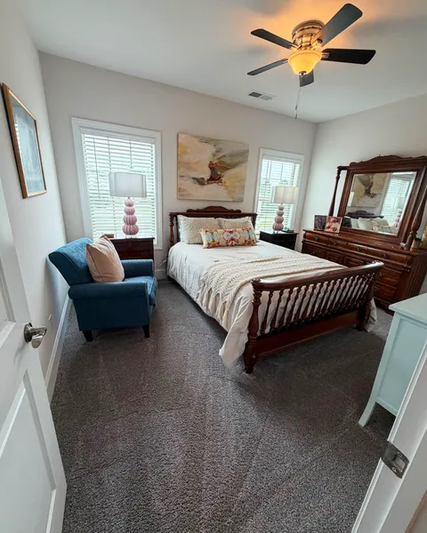 Neatly made bed and tidy, spotless bedroom after cleaning in a Lexington SC home
