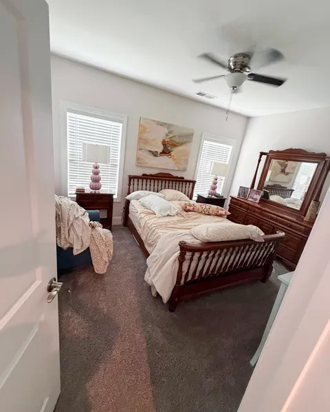 Bedroom with unmade bed and clutter before cleaning in a Lexington SC home